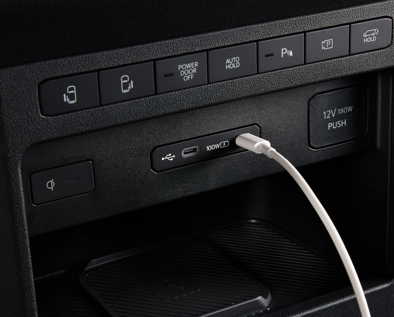 Close-up of the Kia PV5 Cargo dashboard USB port with cable connected