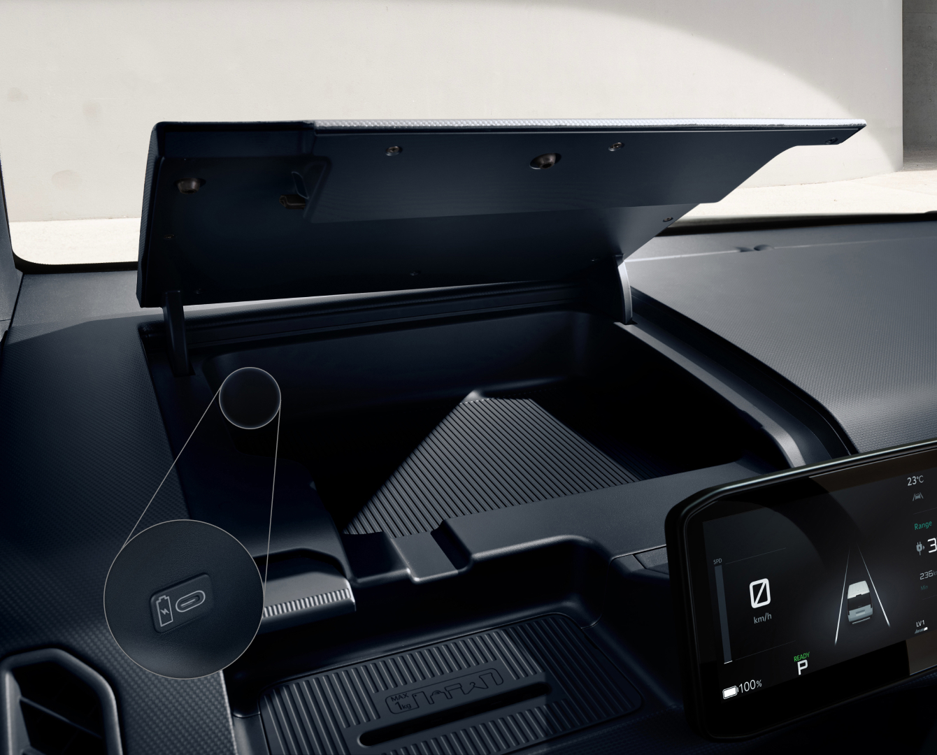 Dashboard storage compartment of the Kia PV5 Cargo being opened