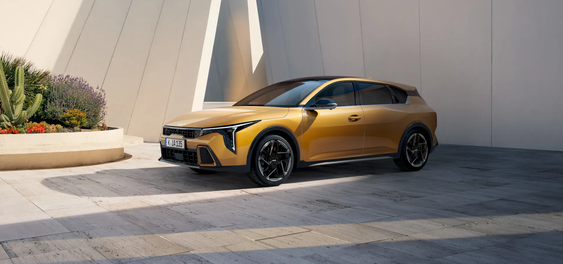 Kia K4 hatch honeycomb yellow front three quarter view parked